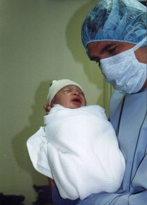 My father met my son first. — Kevin Michael Bagley, in scrubs, holding newborn Torel Richalbe Bagley. November 13, 1998.