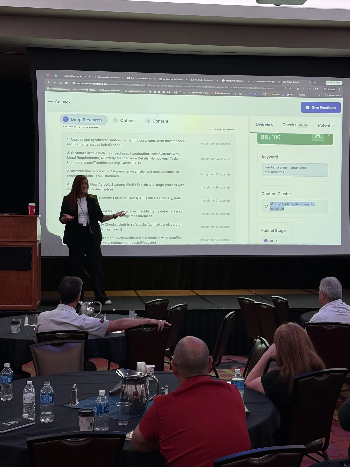 Speaking to dealers in New York, hosted by Meier Supply. — On the screen behind me: Cortex Pulse running live, showing the AI thinking-process for an aerobic-system maintenance article. The work is happening in front of the audience.