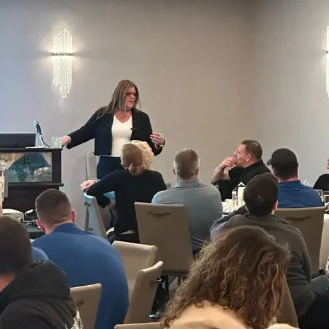 Jennifer leading an intimate workshop with close audience engagement
