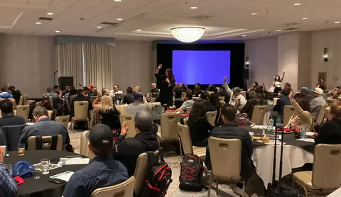 Jennifer engaging a large audience at an interactive workshop