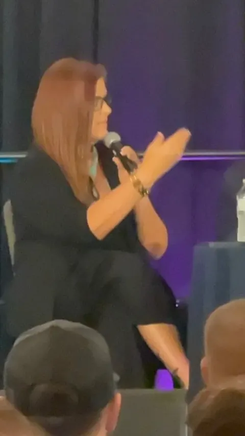Jennifer live on the mic for a full room
